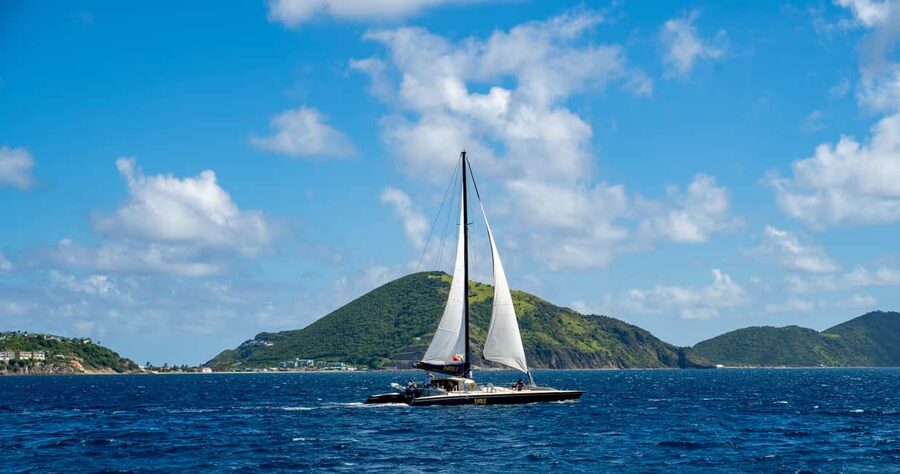 A catamaran on The Narrows with Nevis Peak beyond